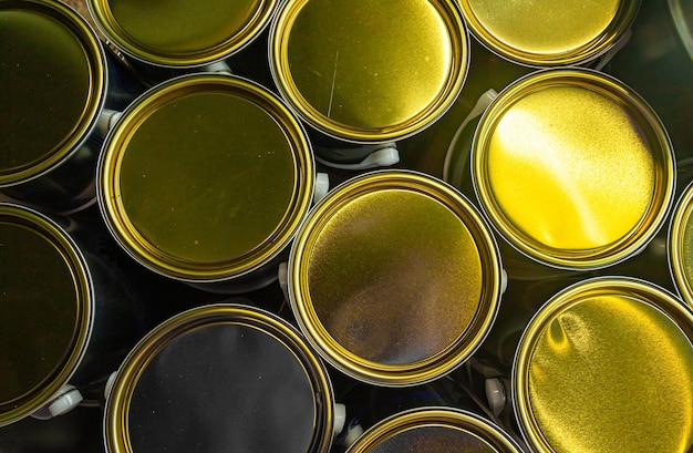 closed-new-paint-cans-with-golden-lids-closeup_187194-816