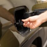 closeup-man-opening-ev-vehicle-inlet-port-attach-electric-cable_482257-130225