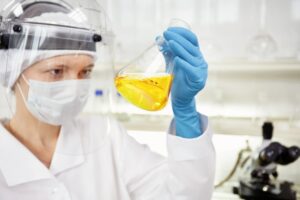 closeup-portrait-female-scientist-holding-conical-tube-with-liquid-solutionn_273609-13631