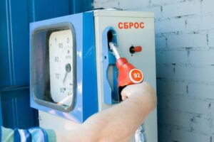 cropped-image-man-holding-fuel-pump-gas-station_97722-175