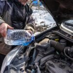 man-pouring-antifreeze-into-special-fluid-tank_298425-539