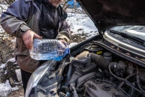 man-pouring-antifreeze-into-special-fluid-tank_298425-539