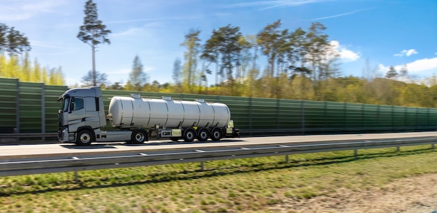 silver-tank-truck-driving-highspeed-highway-commercial-vehicle-moves-along-road_169016-73091