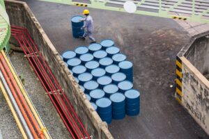 top-view-oil-barrels-vertical-move-male-worker-help-arrange_478515-4023